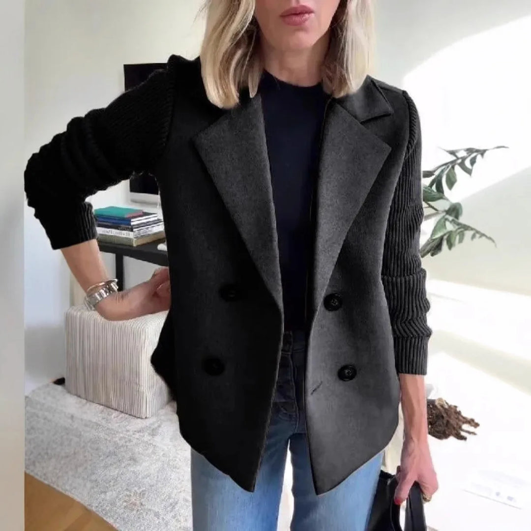 Woman wearing black double-breasted blazer with ribbed knit sleeves