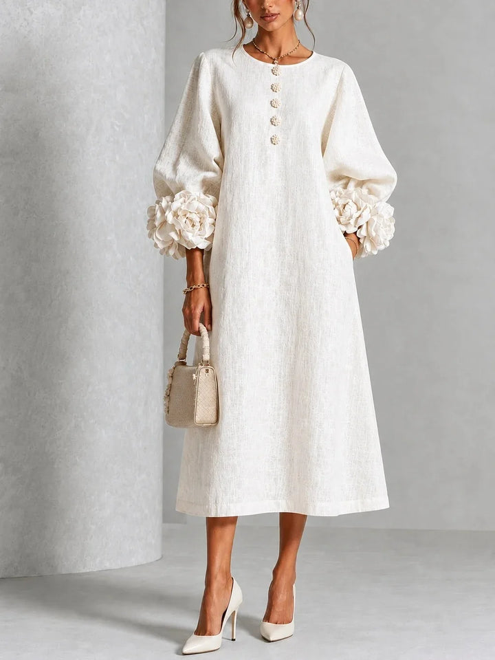 Woman wearing white midi dress with 3D floral lantern sleeve cuffs