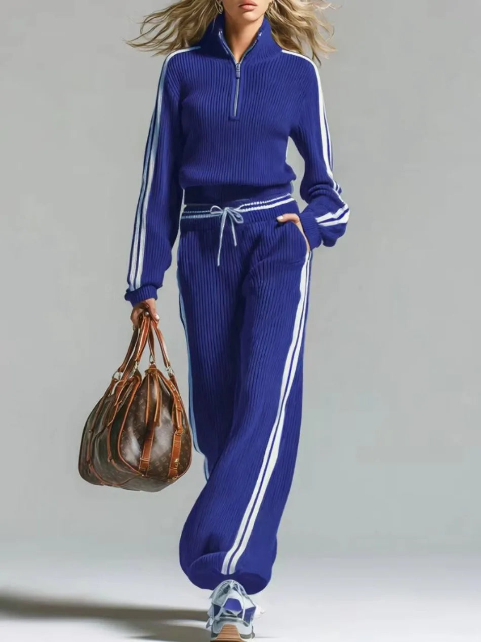 Woman wearing blue ribbed knit two piece set with half zip collar and wide leg pants