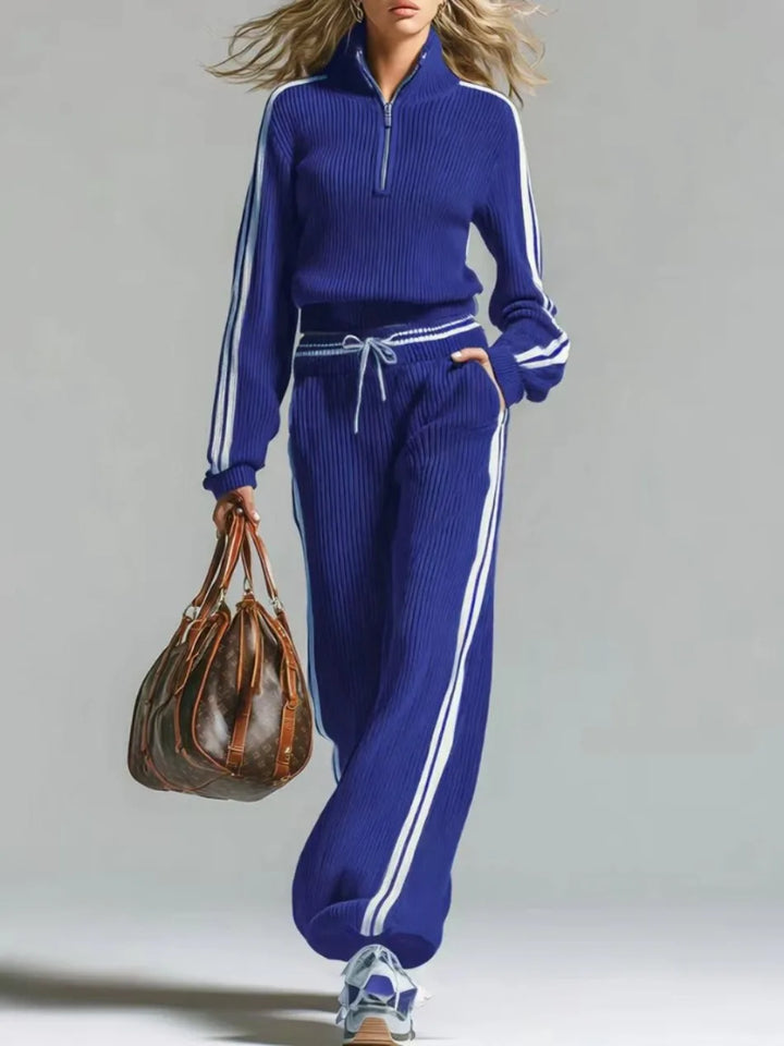 Woman wearing blue ribbed knit two piece set with half zip collar and wide leg pants