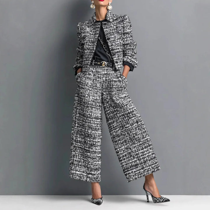 Woman wearing black and white tweed cropped jacket and wide leg pants set