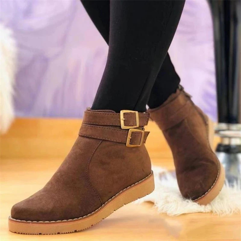 Brown suede ankle boot with double buckle straps, side view