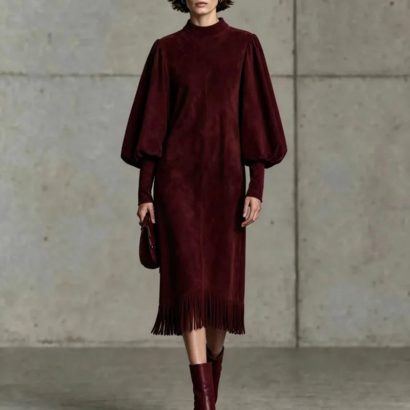 Woman wearing wine red velvet lantern sleeve dress with fringe hem, front view close