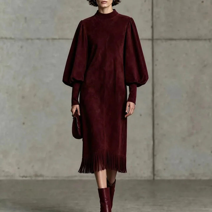Woman wearing wine red velvet lantern sleeve dress with fringe hem, front view close