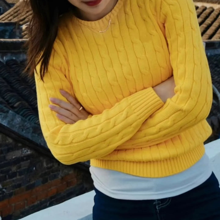 Yellow cable knit sweater detail on model