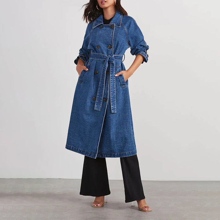 Woman modeling blue denim trench coat with tie belt front view