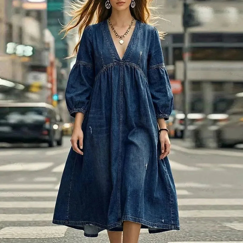 Woman in medium blue denim maxi dress with puff sleeves, front view