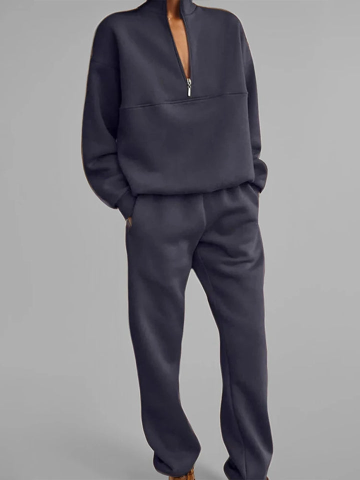 Woman wearing navy blue half-zip pullover and jogger set