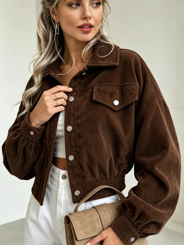 Close up of brown corduroy jacket buttons and flap pocket