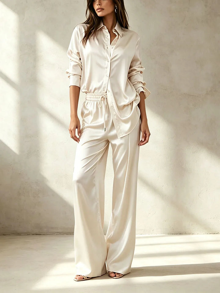 Woman wearing beige satin shirt and pant set, front view