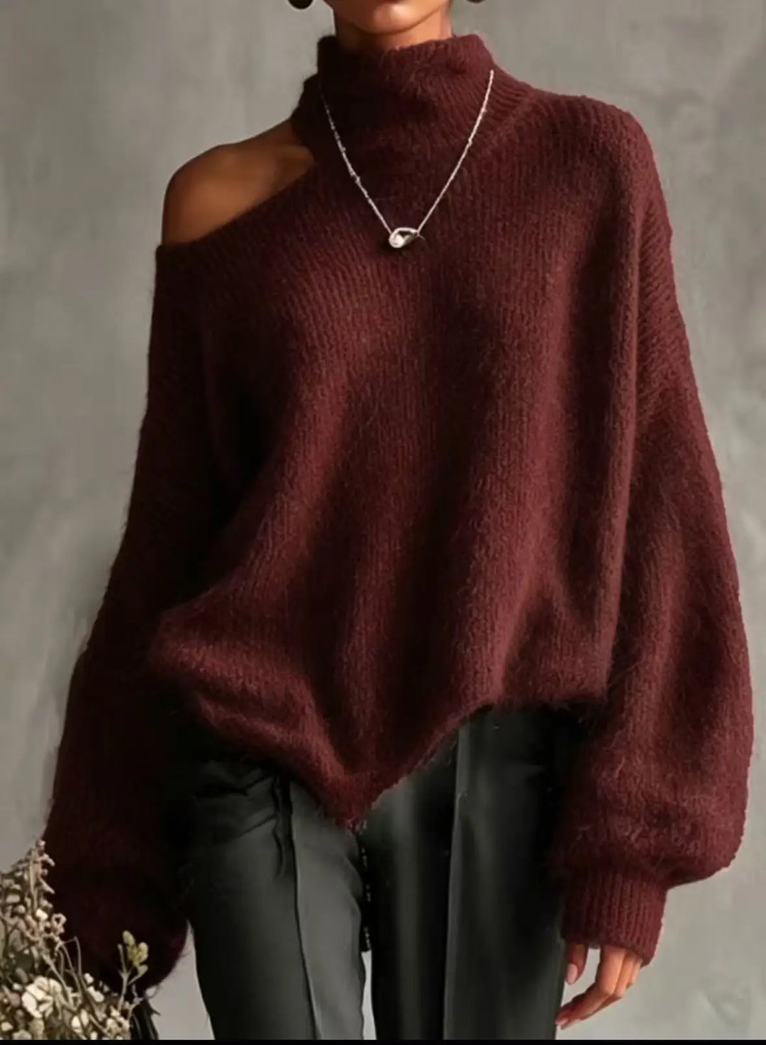 Woman wearing wine red cutout shoulder turtleneck sweater close up