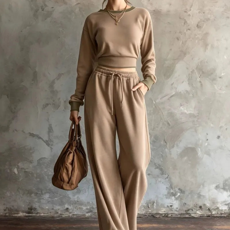 Woman wearing khaki cropped sweatshirt and wide leg pants set with olive trim