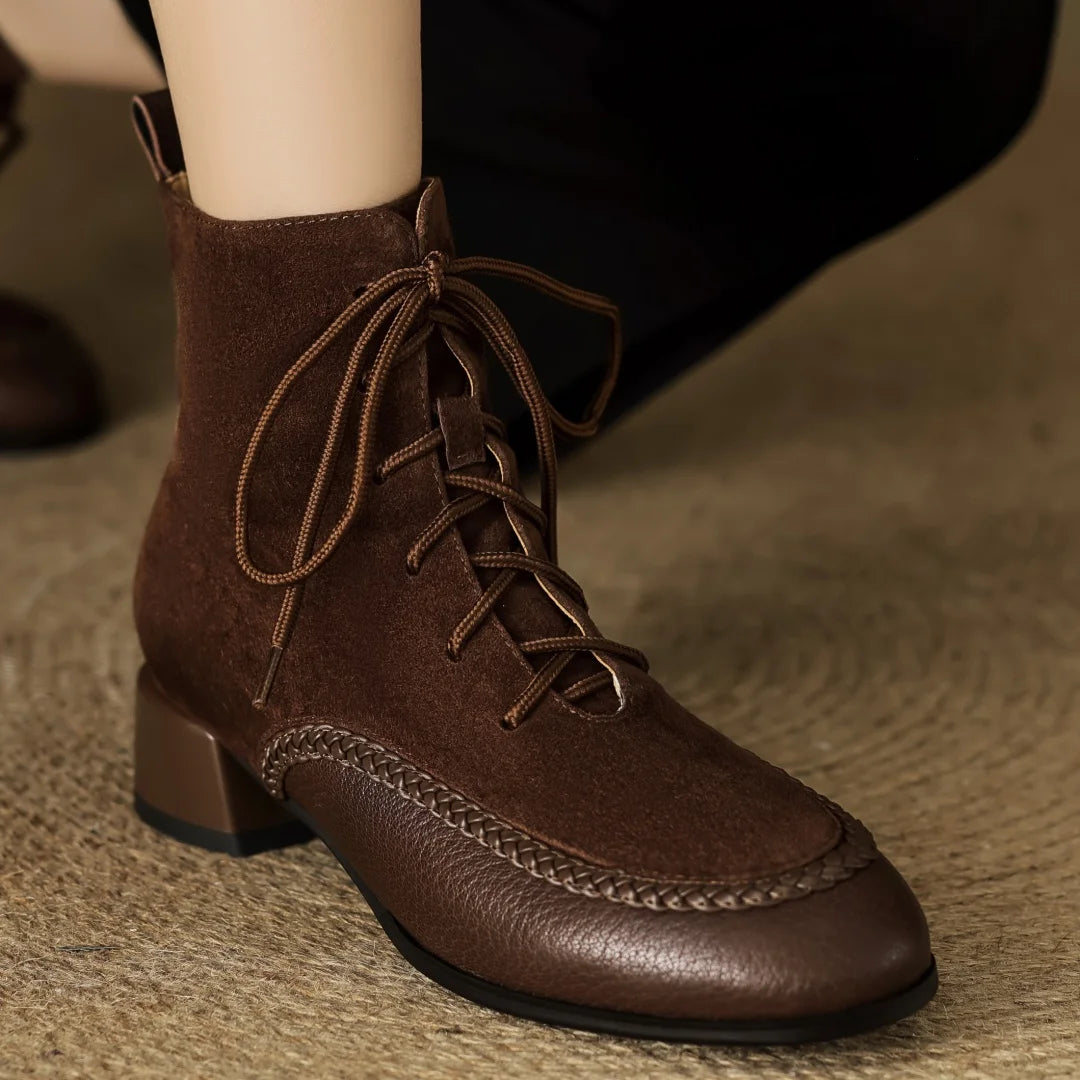 Brown suede lace-up ankle boot close up on foot