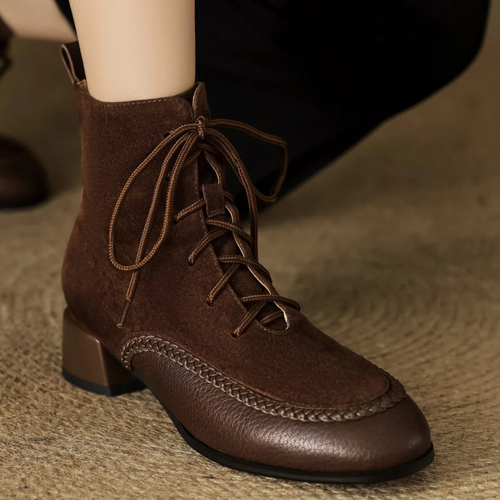 Brown suede lace-up ankle boot close up on foot