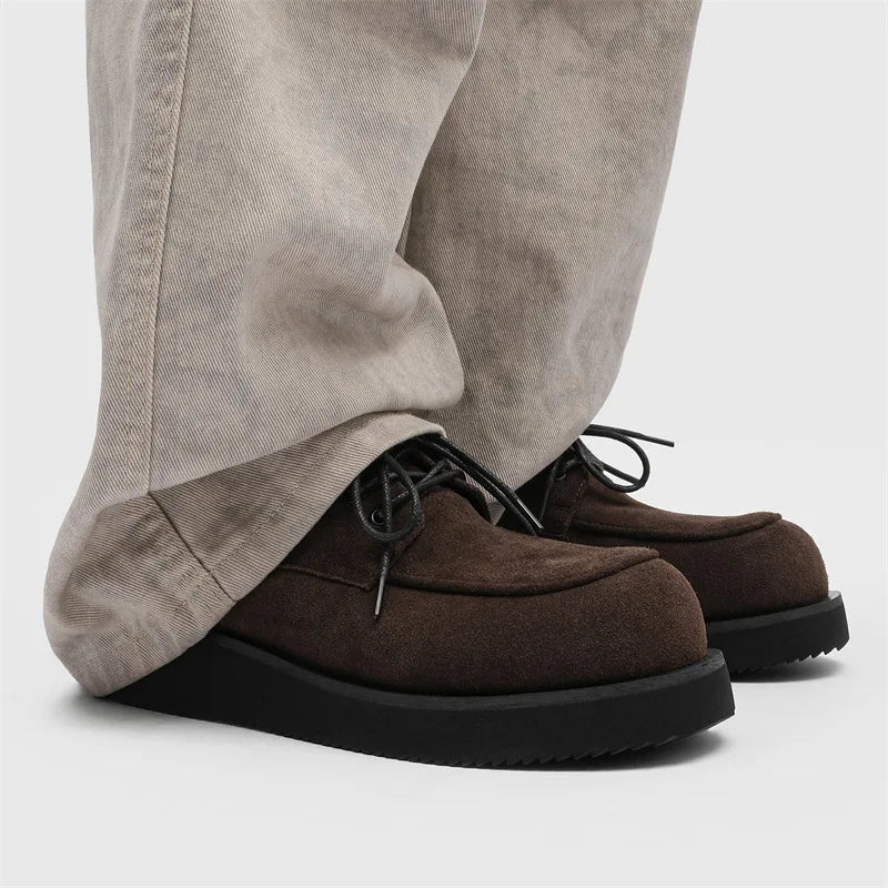 Model wearing brown suede Derby shoes with wide leg pants