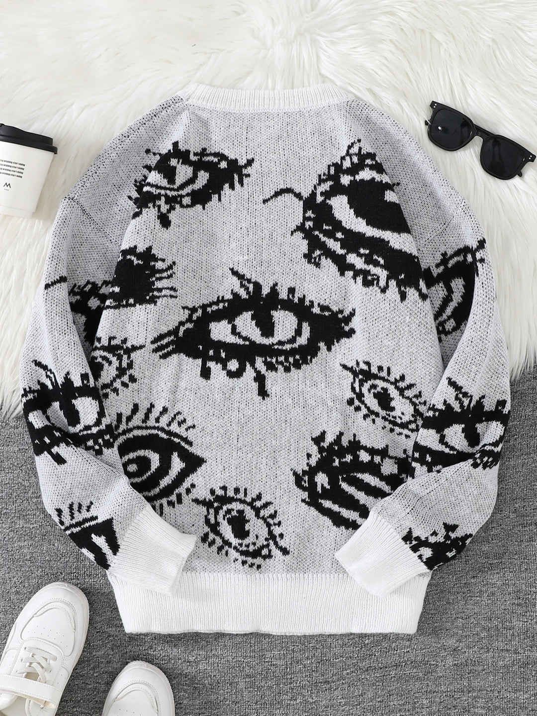 White eye print sweater back view flat lay