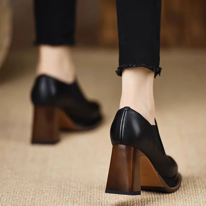 Back view of black leather pumps on model
