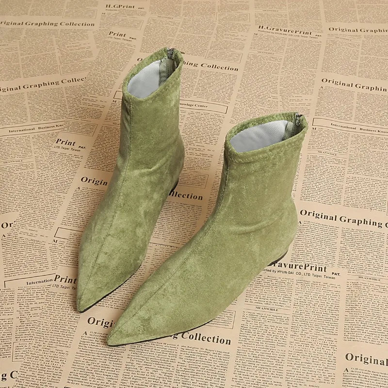 Light green suede ankle boots pair