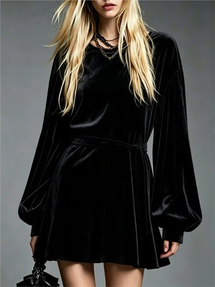 Black velvet mini dress with lantern sleeves and tie belt, front view