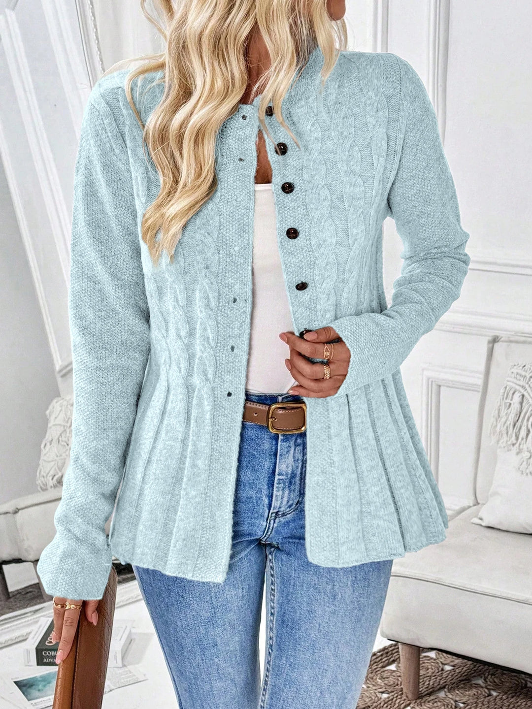 Woman wearing light blue cable knit peplum cardigan front view