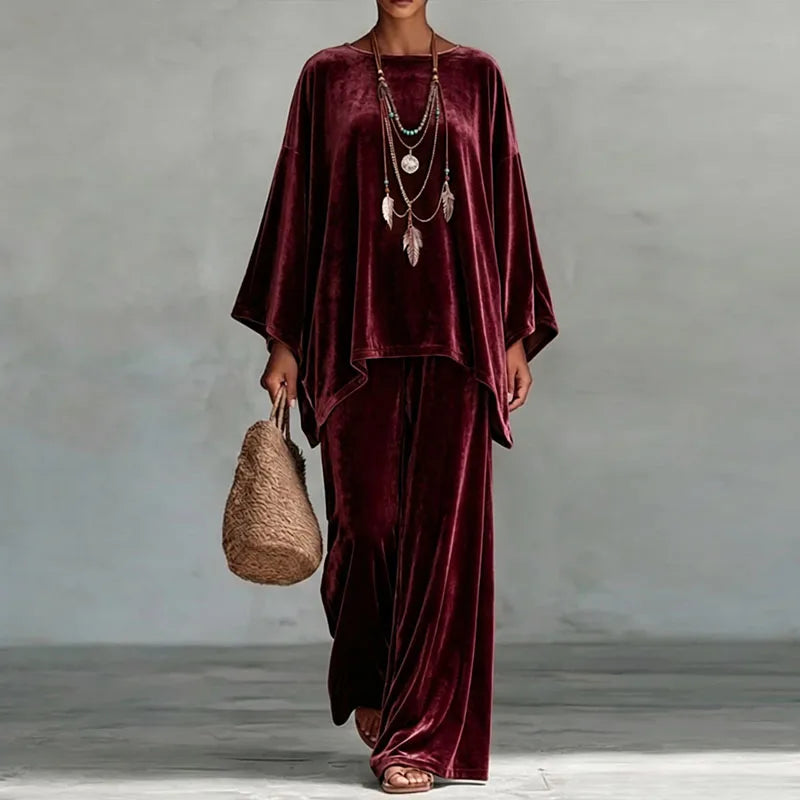 Woman wearing wine red velvet batwing top and wide leg pants set, front view