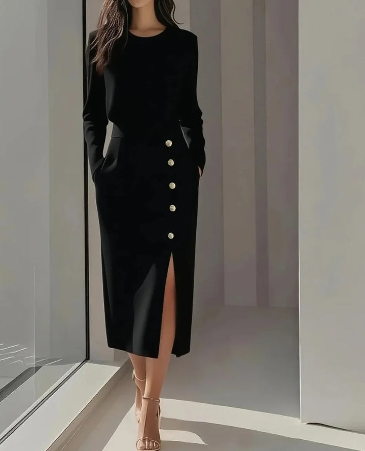 Black midi dress with button detail and side slit, styled with heels, full length view