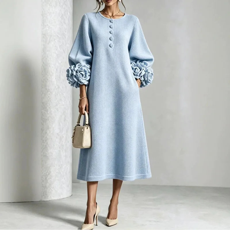 Woman wearing sky blue knit midi dress with floral cuffs