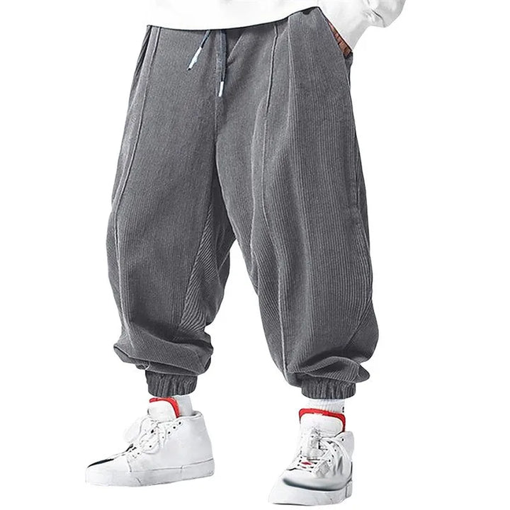 Man wearing grey corduroy jogger pants with drawstring waist