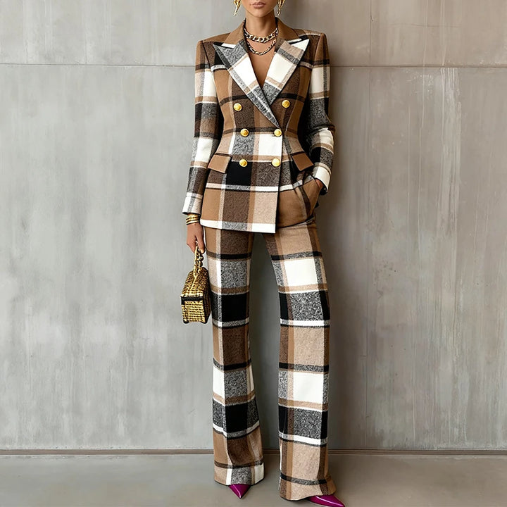 Close view of brown plaid double-breasted blazer and trouser suit against concrete wall
