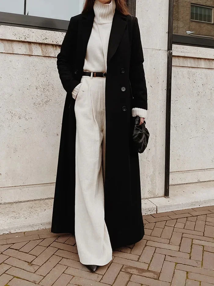 Close view of black trench coat with notched lapel and button closure
