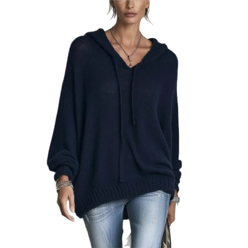 Woman wearing navy hooded knit sweater with drawstring neckline
