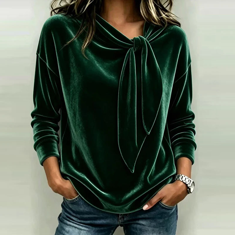 Woman wearing green velvet bow neck pullover top