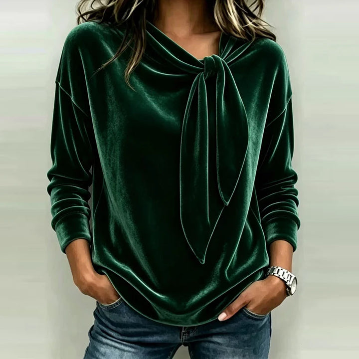Woman wearing green velvet bow neck pullover top
