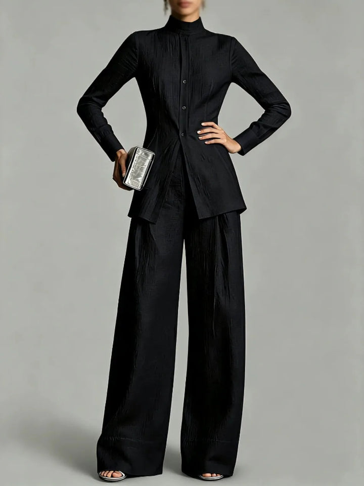 Woman wearing black mock neck top and wide leg pants set, front view