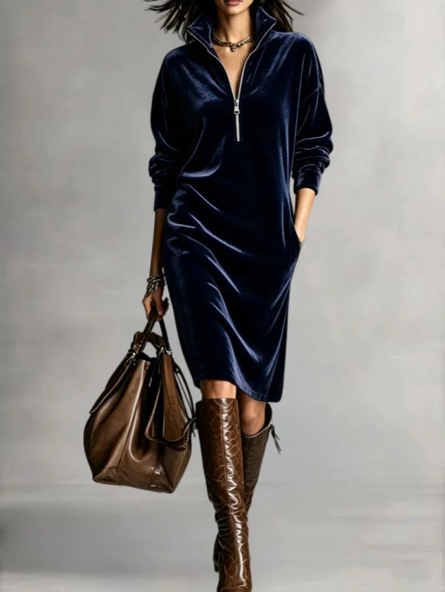 Woman in navy blue velvet half-zip midi dress