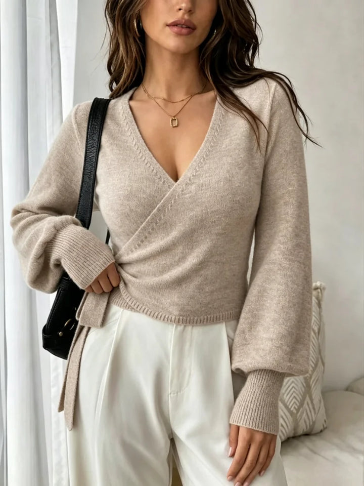 Model wearing beige wrap front cropped sweater with tie waist