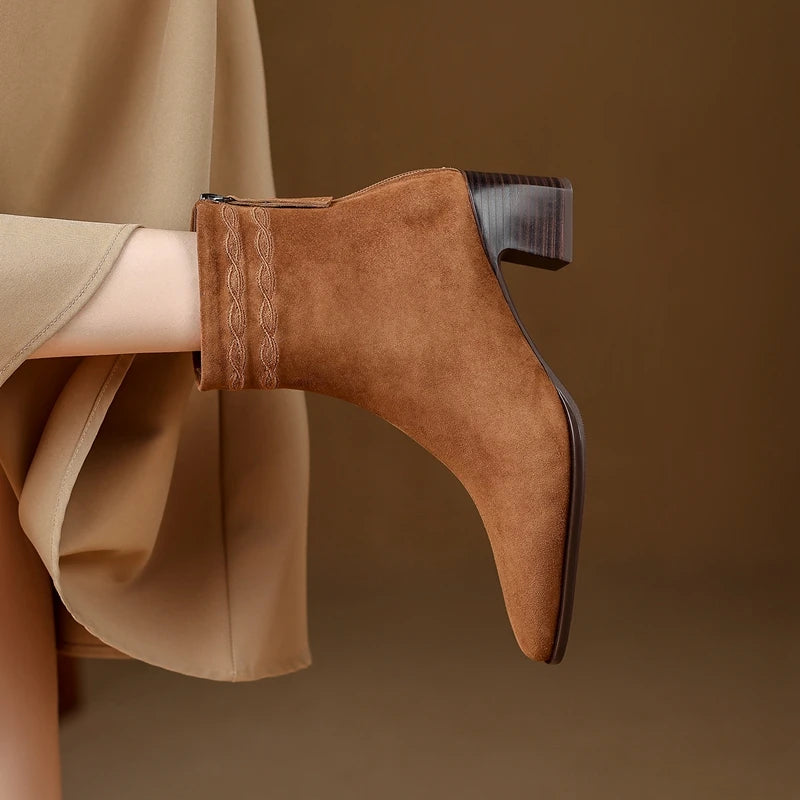 Close up side profile of brown suede ankle boot heel