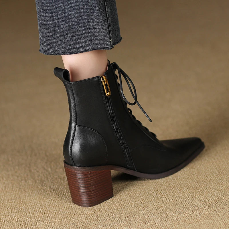 Black leather ankle boot back heel view on model
