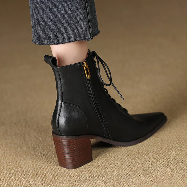 Black leather ankle boot back heel view on model
