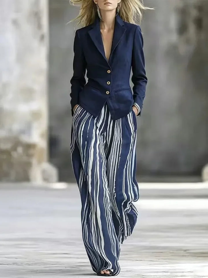 Woman wearing navy blue blazer with striped wide leg pants suit