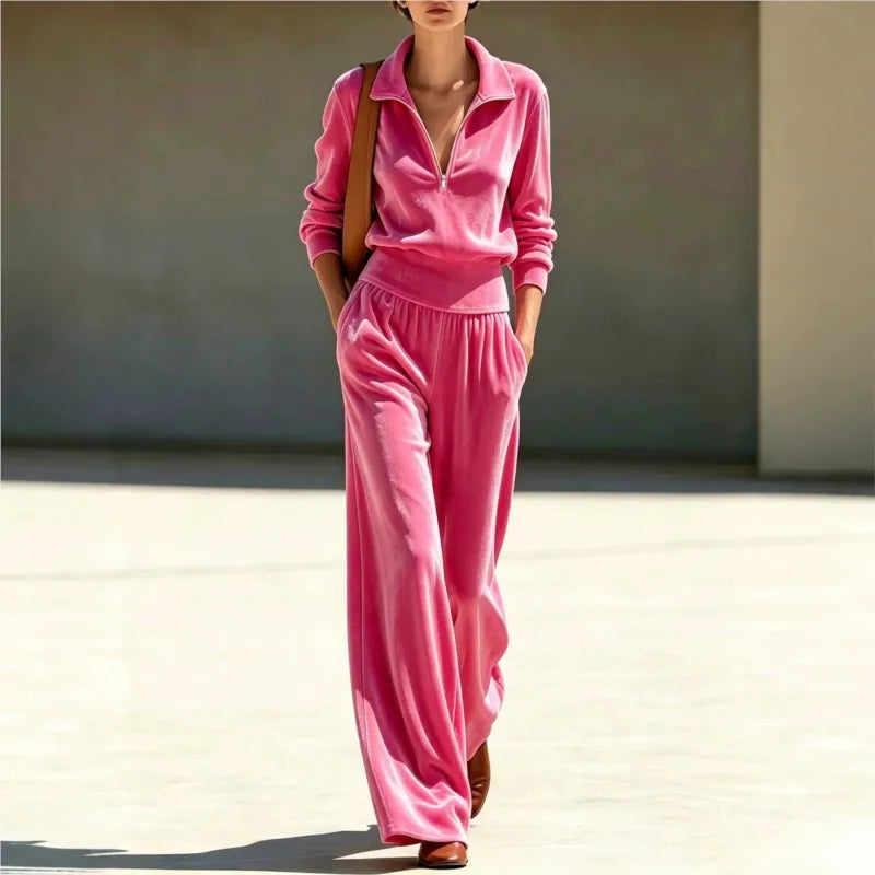 Woman wearing pink velour half-zip top and wide leg pants set, front view walking