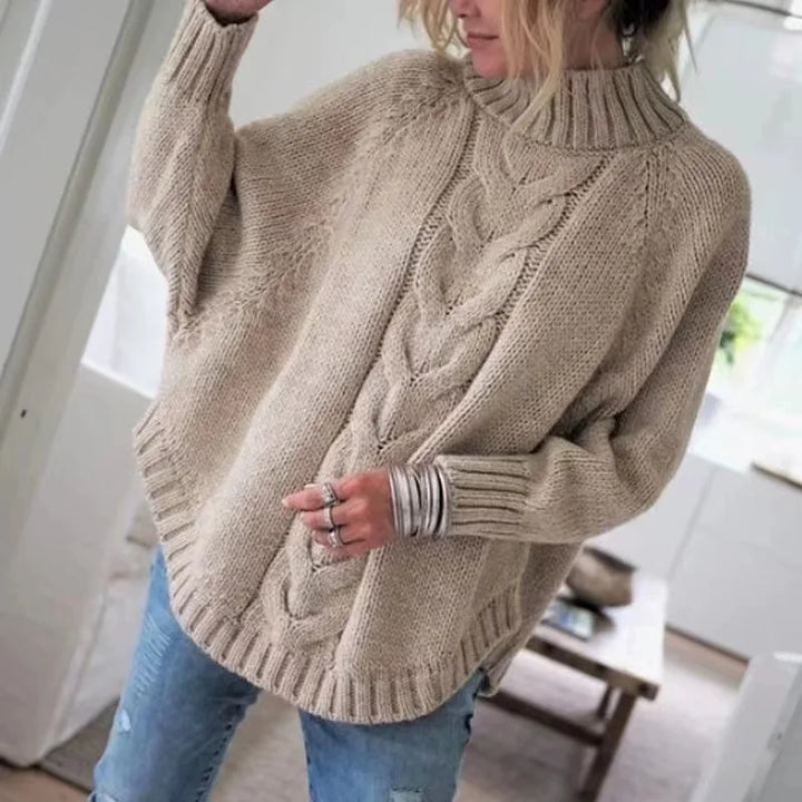 Woman wearing khaki cable knit oversized sweater, front view