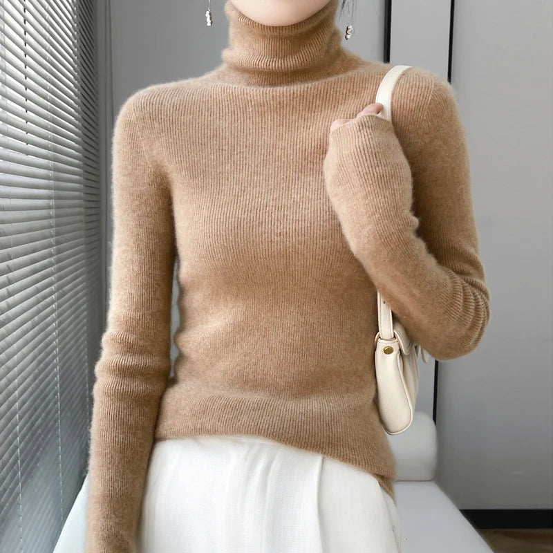 Woman wearing camel ribbed turtleneck sweater with handbag