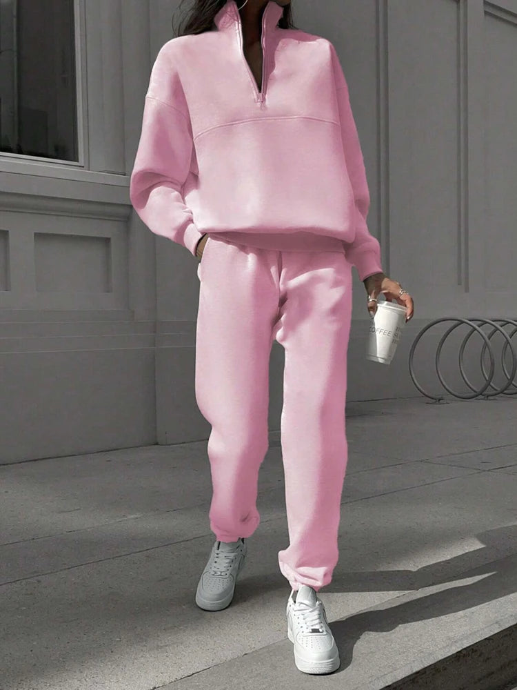 Woman in pink half-zip pullover and jogger set walking