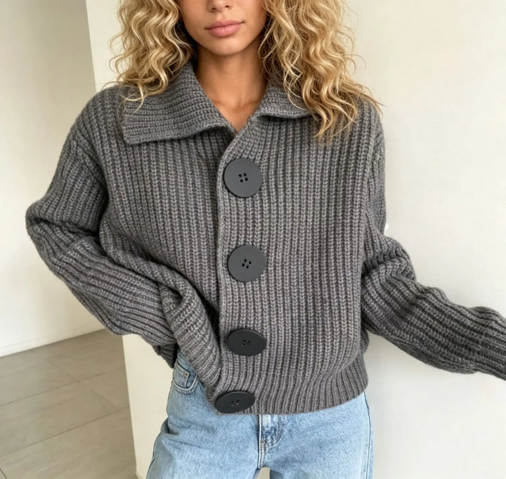 Woman wearing grey knit cardigan with collar and button front detail