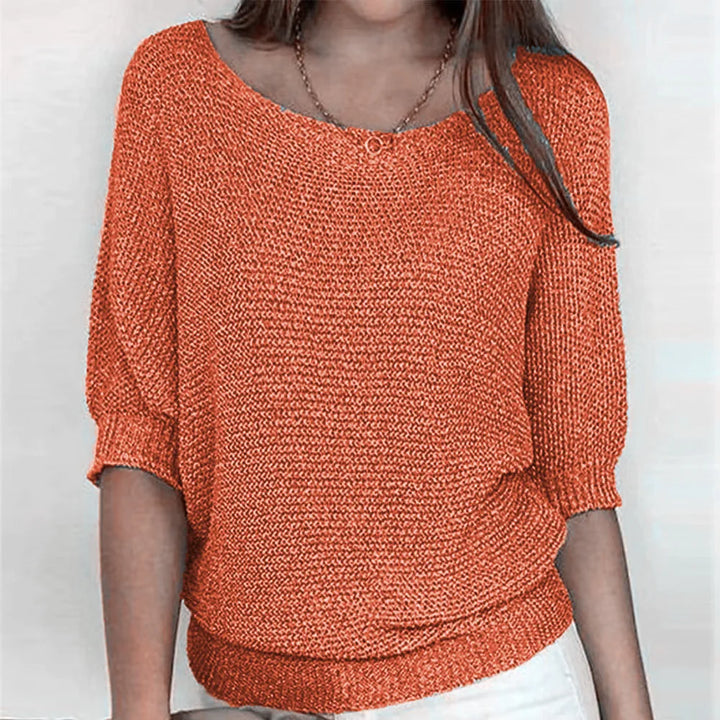 Orange knit top with scoop neckline and three-quarter batwing sleeves
