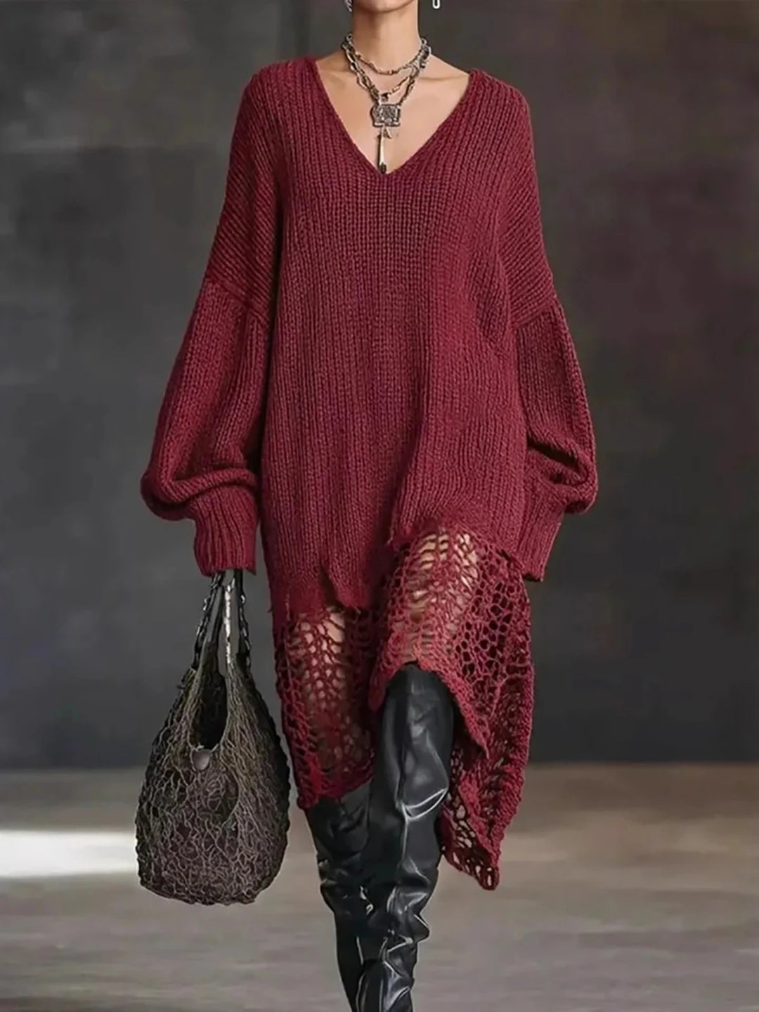 Model in red oversized crochet-hem sweater dress with over-the-knee boots
