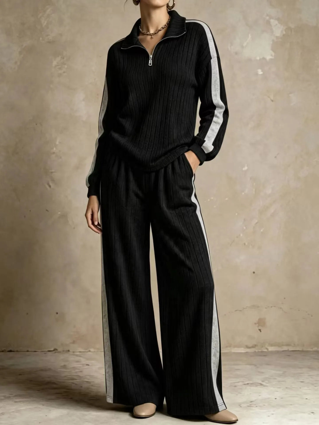 Woman wearing black ribbed knit two piece set with gray side stripe