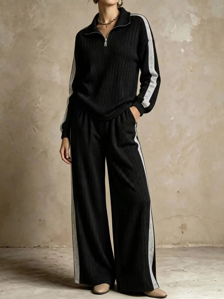 Woman wearing black ribbed knit two piece set with gray side stripe