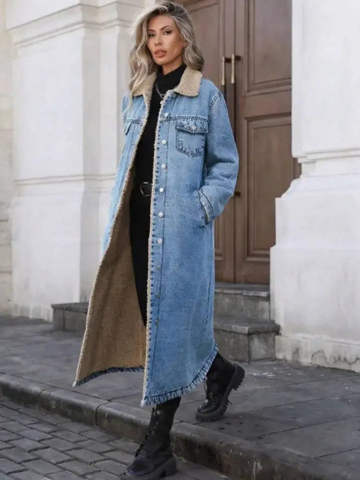 Woman wearing blue denim long coat with sherpa collar, walking outdoors
